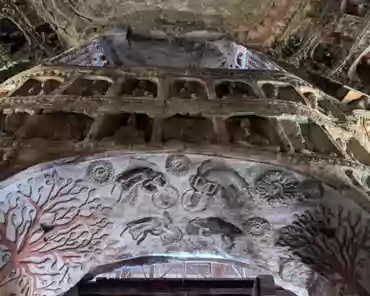 PXL_20241025_024547341 Cave of the Great Buddha. Outside Wooden structures: 1651. Two luxuriant holy trees are carved on the sides of the entrance and two Buddhas seat under the...